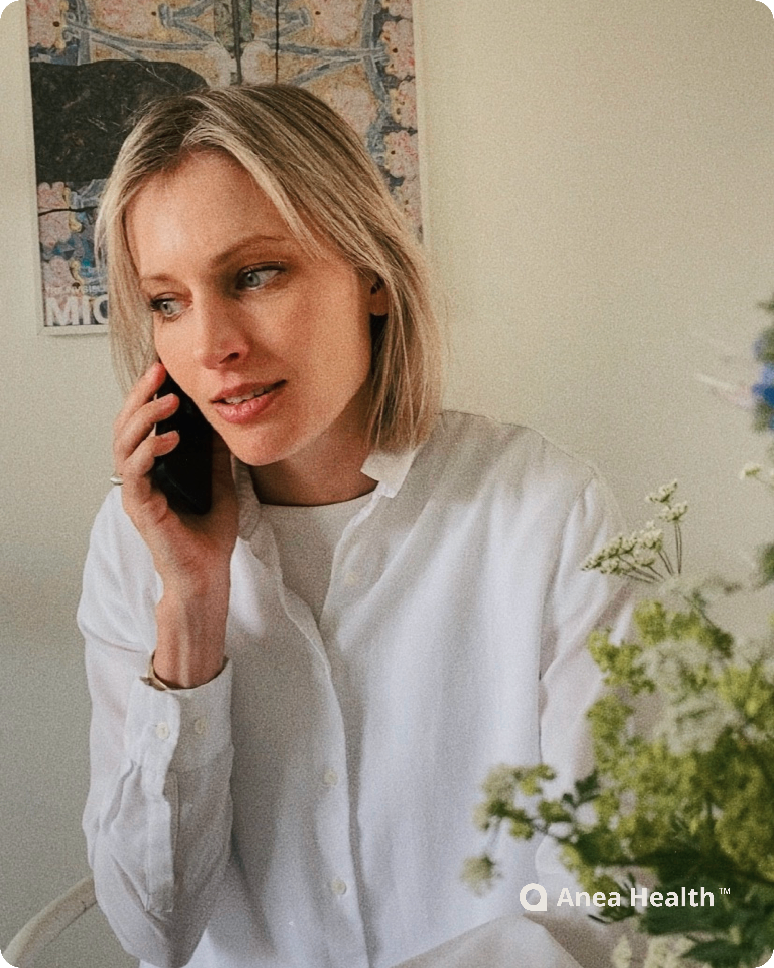 Woman speaking on the phone in a bright room